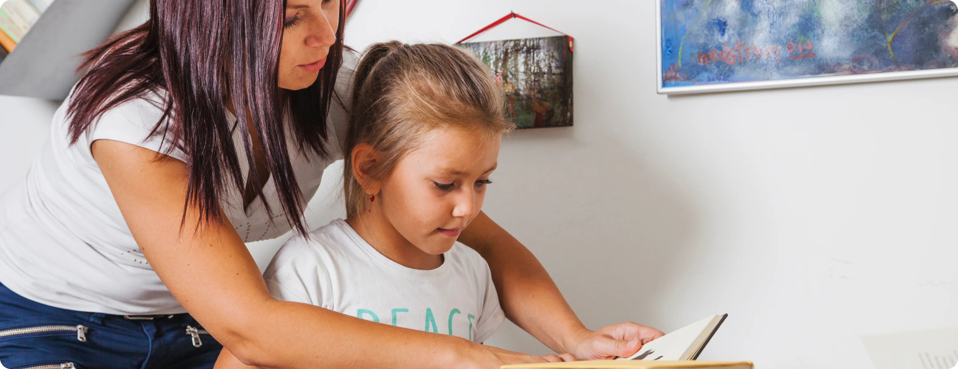 A parent helping a child with reading at home