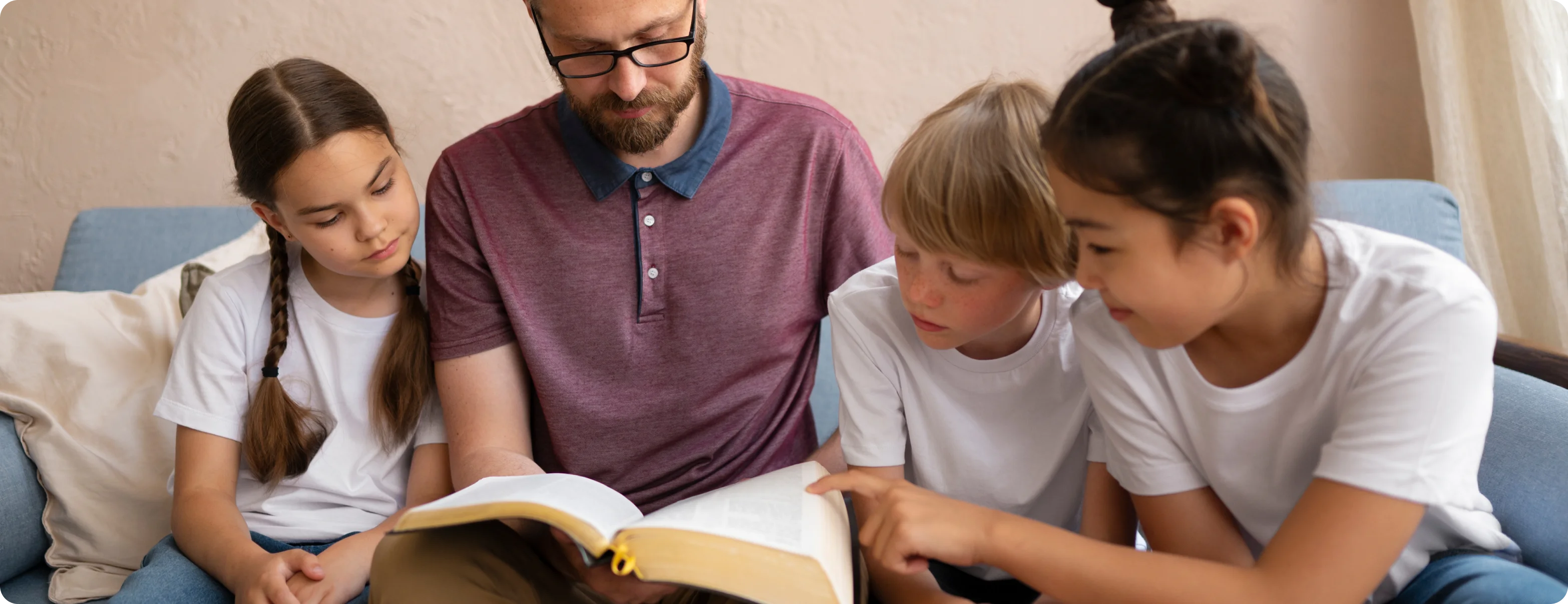 A parent reading to children, highlighting the importance of reading for social-emotional development